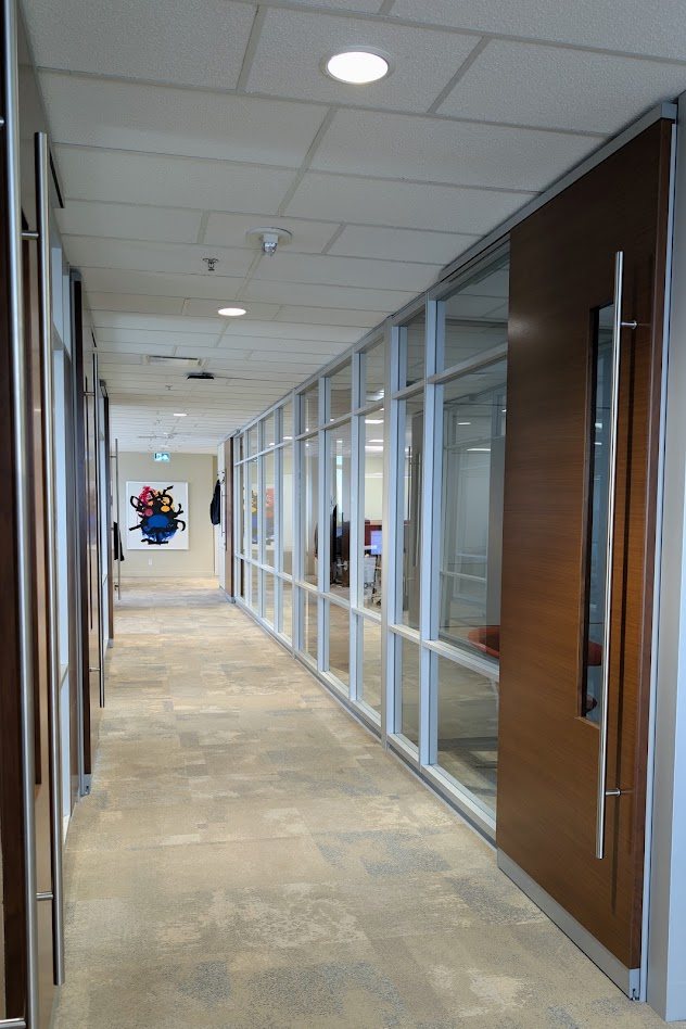 Glass-walled offices along a corridor on the 27th floor of TD Tower